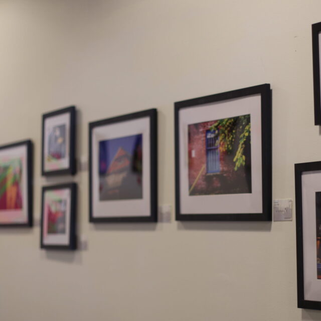 A series of framed photos displayed on a wall.